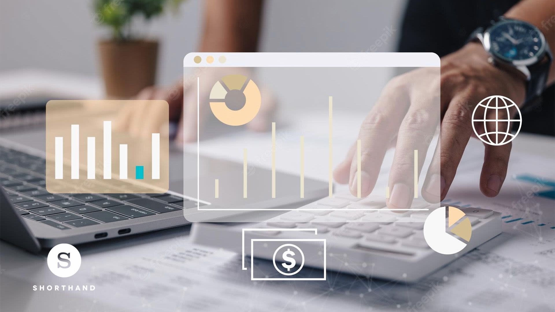 Hand typing on a calculator and laptop.